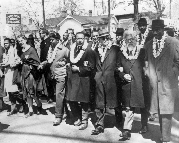 Selma to Montgomery, Alabama March 21, 1965. March leaders (wearing leis) from left to right: John Lewis, a nun, Ralph Abernathy, Martin Luther King, Ralph Bunche, Rabbi Abraham Joshua Heschel and Gregory W. Meeks