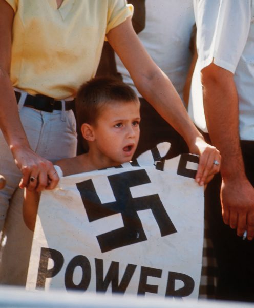 A young boy holds up a “White Power” sign at a counter-demonstration of a civil rights march, in 1966. 