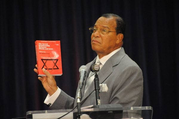 Louis Farrakhan with his book, The Secret Relationship Between Blacks and Jews.